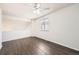 This neutral bedroom is well-lit with hardwood floors and a ceiling fan at 4105 N Dunkirk Ct, Denver, CO 80249