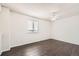 This neutral bedroom is well-lit with hardwood floors and a ceiling fan at 4105 N Dunkirk Ct, Denver, CO 80249