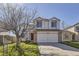 Charming two-story home with a well-maintained lawn, two-car garage and inviting curb appeal at 4105 N Dunkirk Ct, Denver, CO 80249
