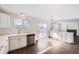 The kitchen has white cabinets, stainless steel appliances, a sliding glass door, and wood flooring at 4105 N Dunkirk Ct, Denver, CO 80249