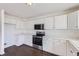 Spacious kitchen featuring white cabinets, stainless steel appliances, and sleek countertops at 4105 N Dunkirk Ct, Denver, CO 80249