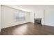 Bright living room boasts wood floors, a modern fireplace, and large window at 4105 N Dunkirk Ct, Denver, CO 80249