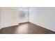 A naturally lit living room with wood floors, a large window, and a bright white front door at 4105 N Dunkirk Ct, Denver, CO 80249