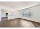 Spacious living room features hardwood floors, large windows, and an open kitchen at 4105 N Dunkirk Ct, Denver, CO 80249