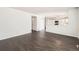 Open living room with hardwood floors leads to a well-lit kitchen at 4105 N Dunkirk Ct, Denver, CO 80249