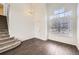 A spacious living room with hardwood floors, a staircase, and large windows that provide natural light at 4105 N Dunkirk Ct, Denver, CO 80249
