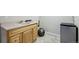 Basement wet bar area featuring a modern vanity, neutral tile floors, and a mini fridge at 6013 S Logan St, Centennial, CO 80121