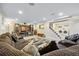 Basement with plush couches, TV area, and access to laundry area at 6013 S Logan St, Centennial, CO 80121