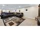 Basement room with dark brown couches, and neutral colored walls at 6013 S Logan St, Centennial, CO 80121