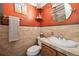 Charming half bathroom features marble-look walls and a unique sink and fixtures at 6013 S Logan St, Centennial, CO 80121