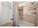 Shower and bathtub with marble design and black accents at 6013 S Logan St, Centennial, CO 80121