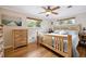 Bright bedroom with wood floors, ceiling fan, and natural light from two windows at 6013 S Logan St, Centennial, CO 80121