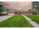Charming brick home featuring a well-manicured lawn, covered porch, and attached garage at 6013 S Logan St, Centennial, CO 80121