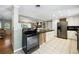 Open kitchen with stainless steel appliances and access to the dining and living rooms at 6013 S Logan St, Centennial, CO 80121