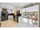 Open kitchen with stainless steel appliances and breakfast bar leading to the dining area at 6013 S Logan St, Centennial, CO 80121