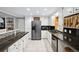 Bright kitchen features white cabinets, stainless steel appliances, and speckled granite countertops at 6013 S Logan St, Centennial, CO 80121