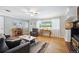 Cozy living room with hardwood floors, a ceiling fan, and ample natural light at 6013 S Logan St, Centennial, CO 80121