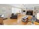 Cozy living room featuring hardwood floors, fireplace, and plenty of natural light at 6013 S Logan St, Centennial, CO 80121