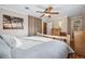 Comfortable bedroom with natural wood decor, ceiling fan, and beach artwork at 6013 S Logan St, Centennial, CO 80121