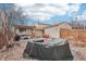 Backyard with pergola, hot tub, seating area, fire pit, and decorative rock waterfall feature at 4314 Nepal St, Denver, CO 80249