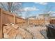 Backyard with rock garden, decorative bench, birch trees and wood fencing at 4314 Nepal St, Denver, CO 80249