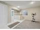 Finished basement area featuring tile and carpet flooring, wet bar, and exercise space at 4314 Nepal St, Denver, CO 80249