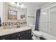 Cozy bathroom with granite countertops, a large mirror, and a shower-tub combination at 4314 Nepal St, Denver, CO 80249