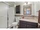 Well-maintained bathroom with granite countertops, a shower, and decorative wall tiles at 4314 Nepal St, Denver, CO 80249