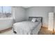 Serene bedroom with a comfortable bed, large window, and modern lamp at 4314 Nepal St, Denver, CO 80249