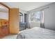 Bright bedroom with light gray walls, a large window, and carpet flooring at 4314 Nepal St, Denver, CO 80249