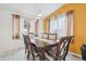 Elegant dining room featuring a wood table, decorative chairs, and natural light from the nearby windows at 4314 Nepal St, Denver, CO 80249