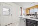 Bright kitchen with a stainless steel dishwasher and dining area at 4314 Nepal St, Denver, CO 80249