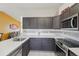 Well-lit kitchen with stainless steel appliances, white countertops, and modern finishes at 4314 Nepal St, Denver, CO 80249