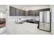 Modern kitchen with stainless steel appliances, sleek countertops, and dark cabinetry at 4314 Nepal St, Denver, CO 80249