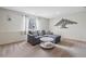 Comfortable living room with a gray sectional sofa and tree art on the wall at 4314 Nepal St, Denver, CO 80249