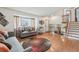 Bright living room featuring hardwood floors, comfortable seating, and a staircase leading upstairs at 4314 Nepal St, Denver, CO 80249