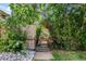 Landscaped backyard with mature trees and decorative gate at 3328 Bryant St, Denver, CO 80211