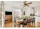 Bright dining room features hardwood floors, a decorative ceiling fan, and a table set for a lovely meal at 3328 Bryant St, Denver, CO 80211