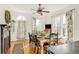 Sunlit dining room with wood floors, decorative fireplace, modern furniture, and large windows at 3328 Bryant St, Denver, CO 80211