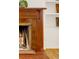 Close-up of the fireplace with a detailed mantle and decorative tiles and vintage design at 3328 Bryant St, Denver, CO 80211