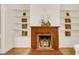 Elegant fireplace featuring built-in shelves and a decorative wooden mantel at 3328 Bryant St, Denver, CO 80211