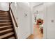 Hallway with wooden staircase leading to a room with a fireplace and built in bookshelves at 3328 Bryant St, Denver, CO 80211