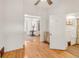 Hallway features hardwood floors, white walls, and multiple archways and an open doorway at 3328 Bryant St, Denver, CO 80211