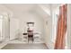 Bright home office space with white walls, a window with curtains, and a stylish area rug at 3328 Bryant St, Denver, CO 80211