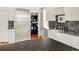 Well-appointed kitchen featuring stainless steel appliances, white cabinets, and a farmhouse sink at 3328 Bryant St, Denver, CO 80211