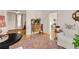 Bright living room with hardwood floors, white furniture, and an antique wooden cabinet at 3328 Bryant St, Denver, CO 80211