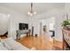 Bright living room features hardwood floors, vintage fireplace, and decorative details throughout at 3328 Bryant St, Denver, CO 80211