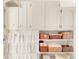 Bright storage with cupboards and shelving, blending functionality with an airy design at 3328 Bryant St, Denver, CO 80211