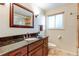 Updated bathroom with dark vanity, granite countertop, and shower at 7024 E Montana Pl, Denver, CO 80224