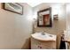 Small powder room with vanity and mirror at 7024 E Montana Pl, Denver, CO 80224